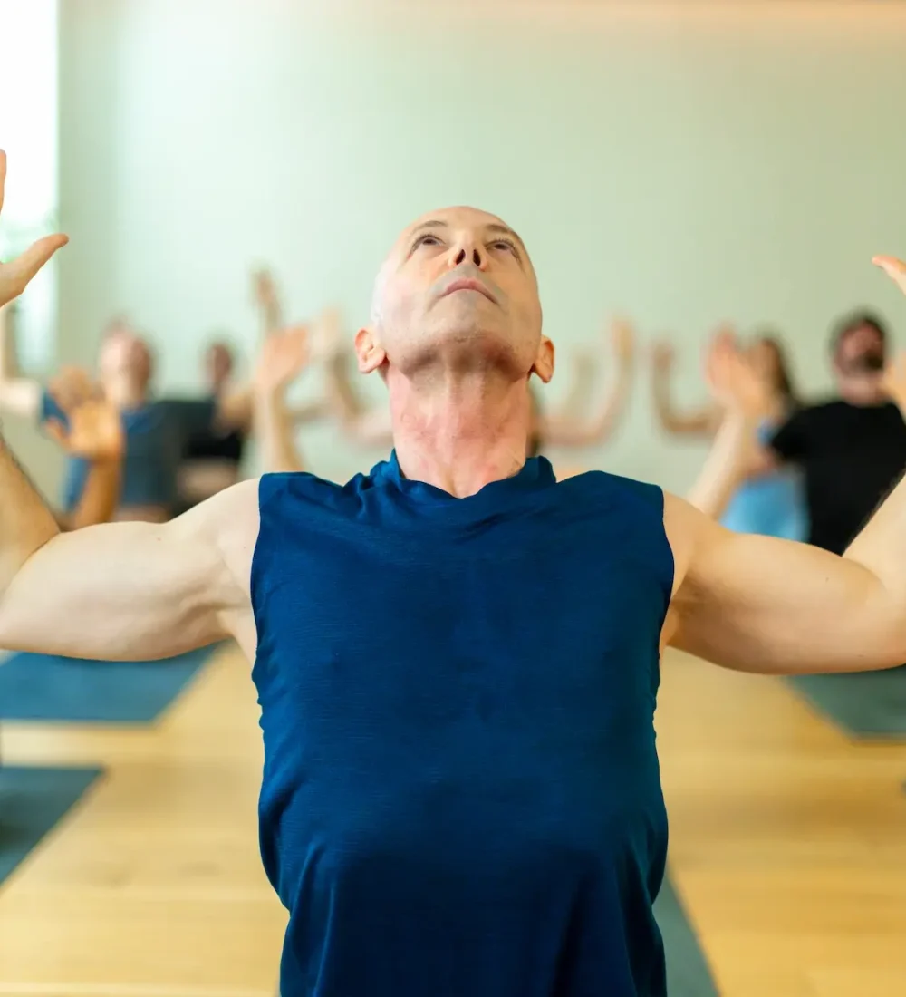 middle-aged-man-practices-an-expressive-yoga-pose-2025-03-05-16-41-20-utc